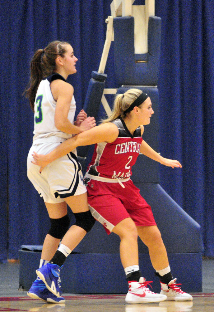 University of Maine at Augusta forward Jamie Plummer, left, and Central Maine Community College’s Seve Deery-DeRaps battle for position under basket Thursday in the Augusta Civic Center.