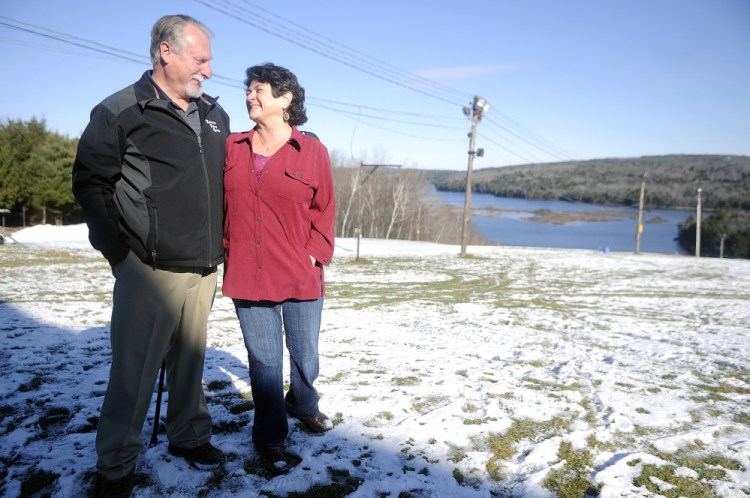 Marlee Johnston’s parents, Ted Johnston and Marlene Thibodeau, stand at the ski slope at Kents Hill School in Readfield last week. Marlee had planned to enroll in the school before she was killed 10 years ago. The couple raises funds for the private high school and sponsors a ski competition in her memory.