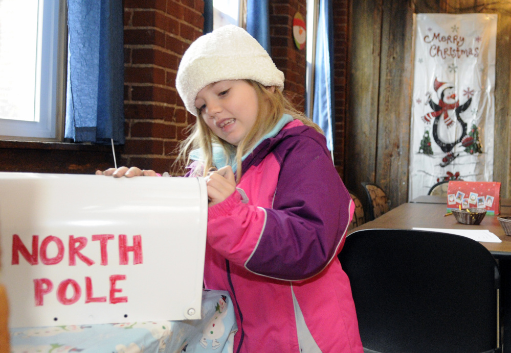 Grace Smith, 7 of Augusta, closes a mailbox after depositing her letter to Santa Claus during The Riverfront Holiday event on Saturday in downtown Augusta.