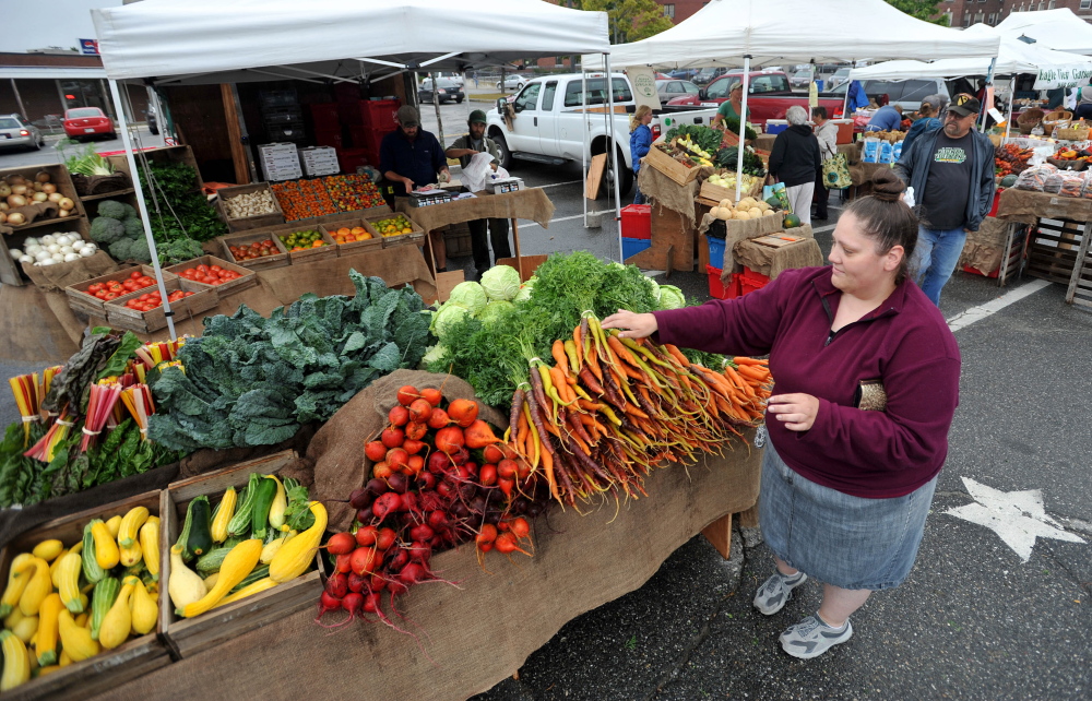 Naomi York, of Oakland, finds some color at the Waterville Farmer’s Market in September 2014. The market is moving indoors for the winter to the MaineGeneral Thayer Center for Health on North Street, a new location after there were issues with its winter location last year in The Center downtown.