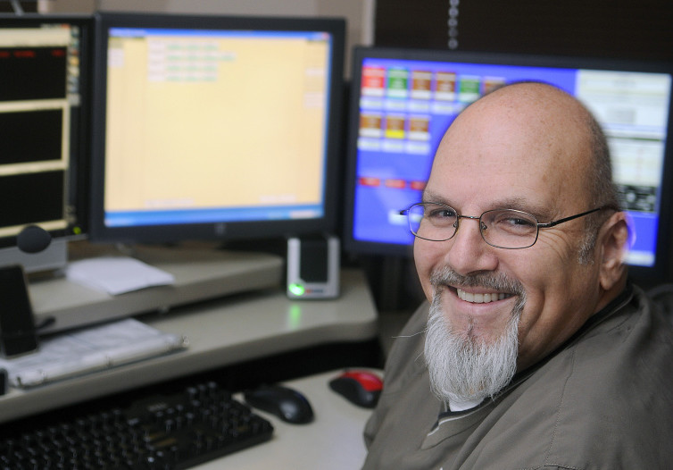 City of Augusta dispatcher Mike Rankins at his console Monday at the police department. Rankins is retiring as a full-time dispatcher after 20 years with Augusta.