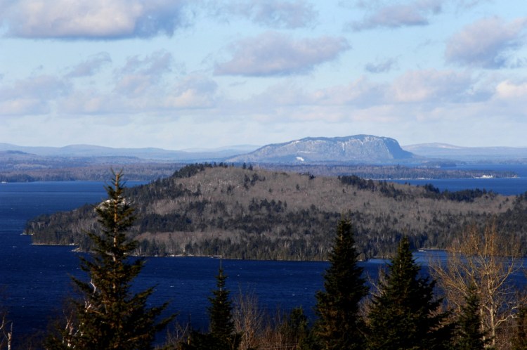 Mount Kineo rises behind Moosehead Lake. Plum Creek, which owns hundreds of thousands of acres in the Moosehead Lake region, is being sold to Weyerhaeuser Co. to form what is expected to be one of the world's largest timberland companies.