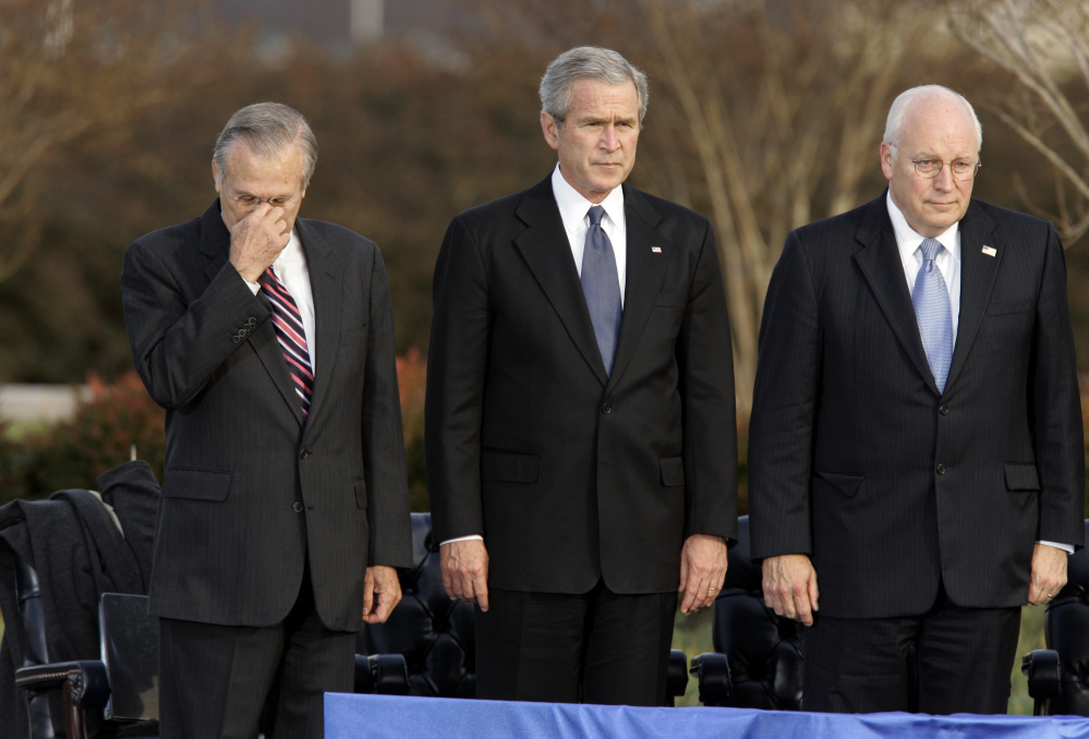 Secretary of Defense Donald Rumsfeld, left, pauses as President George W. Bush and Vice President Dick Cheney participate in Rumsfeld’s farewell ceremony at the Pentagon in 2006.