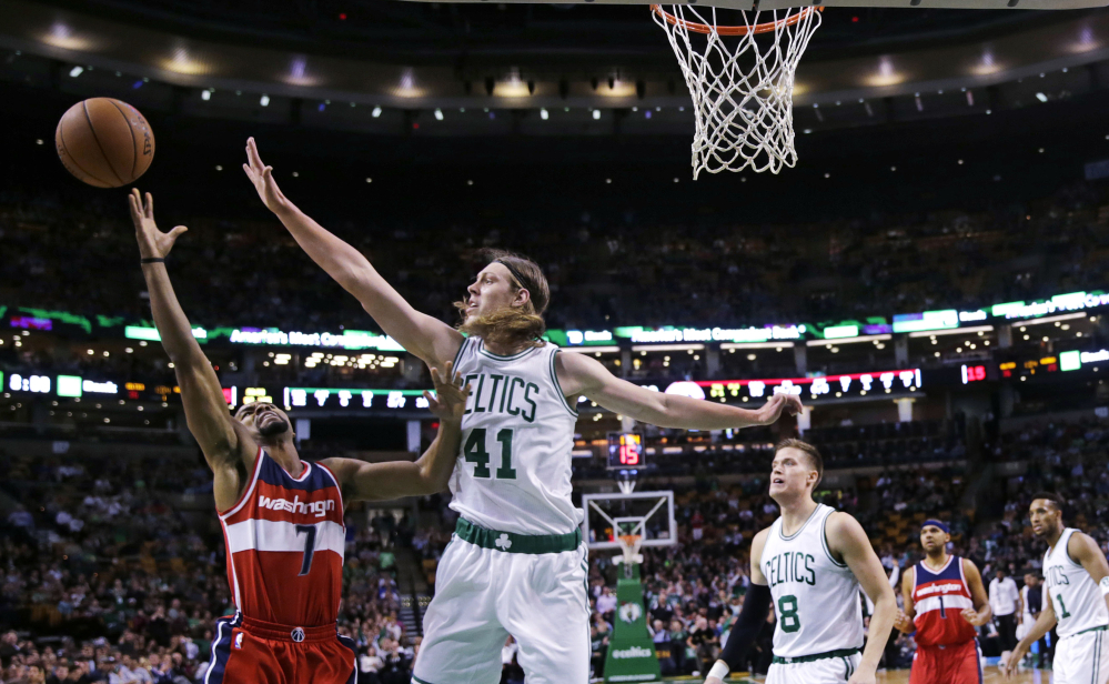 Celtics center Kelly Olynyk blocks a shot by Wizards guard Ramon Sessions in the first quarter of Boston’s lopsided win Friday night. The Celtics outscored Washington 40-25 in the first quarter.