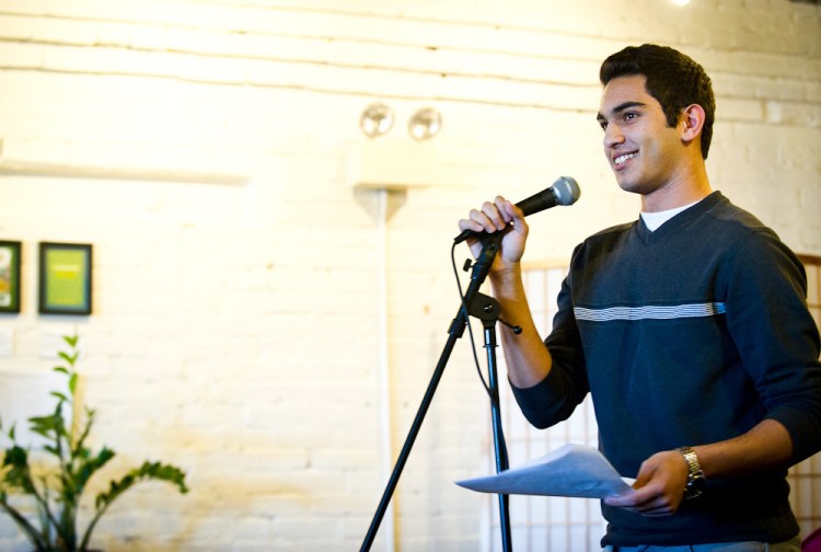 Ibrahim Shkara reads a story to a crowd of over 80 community members, including mentors, at the Telling Room in Portland in June.
Photo by Molly Haley
