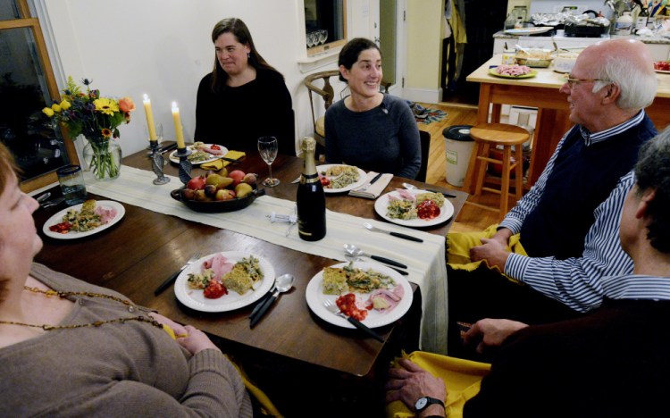 Portland Press Herald food editor Peggy Grodinsky, center, entertains her guests with a variety of food for the Portland Press Herald Signature Dish(es) Thanksgiving dinner.