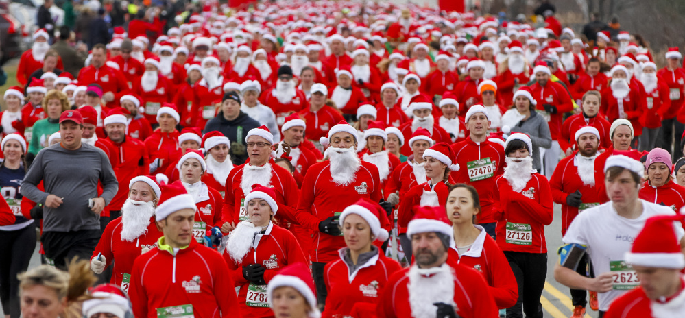 A pack of Santas begins the 5K in the Santa Hustle New England 5K and Half Marathon on Sunday at the Maine Mall.