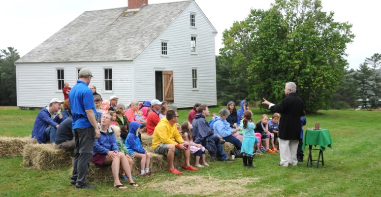 Magician Robert Olsen performs during Pettengill Farm Day. Stewards of the historic farmhouse, known for its etched murals, are dealing with an infestation of powderpost beetles.