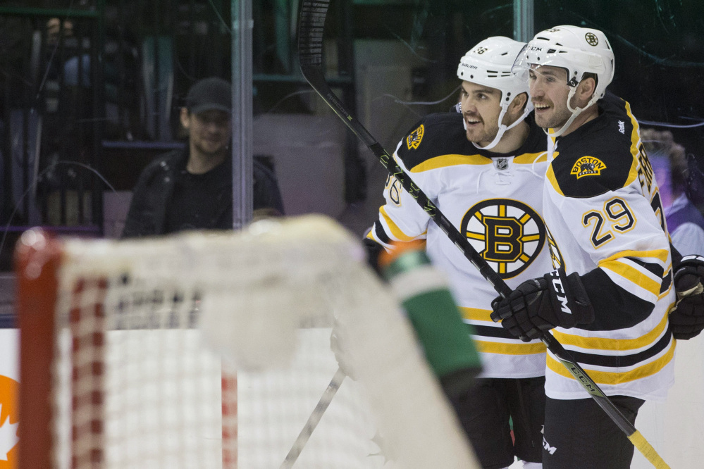 The Bruins’ Zac Rinaldo, left, is congratulated by Landon Ferraro after scoring in the first period of Monday night’s game in Toronto. The Bruins ended up winning in a shootout, 4-3.