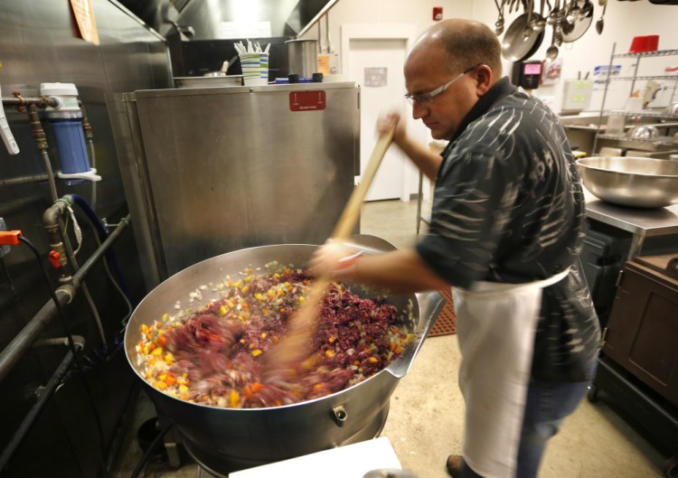 With hunters supplying fresh venison and moose meat from the wilds of Maine, Don Morrison, operations manager at Wayside Food Programs, prepares a shepherd’s pie that will be served to 200 people at a free church dinner in Portland.