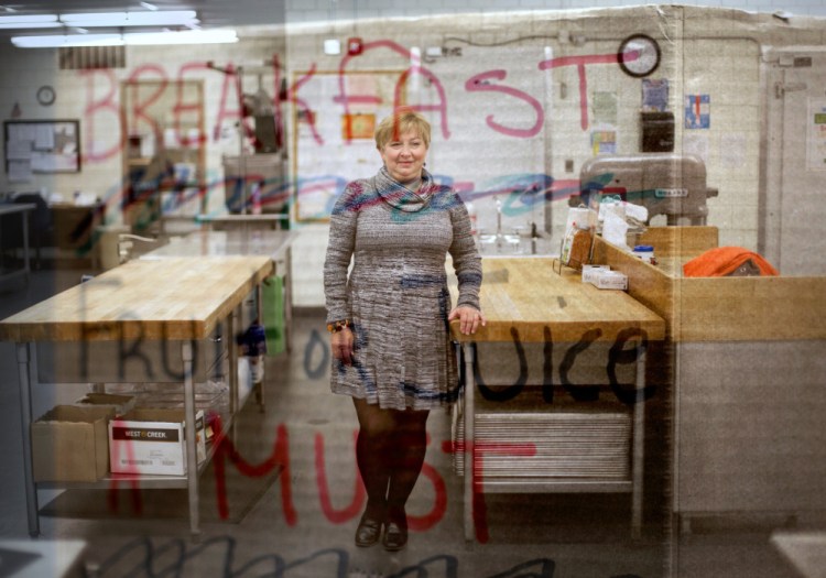 Nutritionist Laura Pineo makes sure the school kitchens of SAD 54, in the Skowhegan area, keep hungry students fed and ready for their lessons. As the superimposed sign declares, fruit and juice are among the items available for breakfast, and lunch can be a variety of hot dishes.
Gabe Souza/Staff Photographer