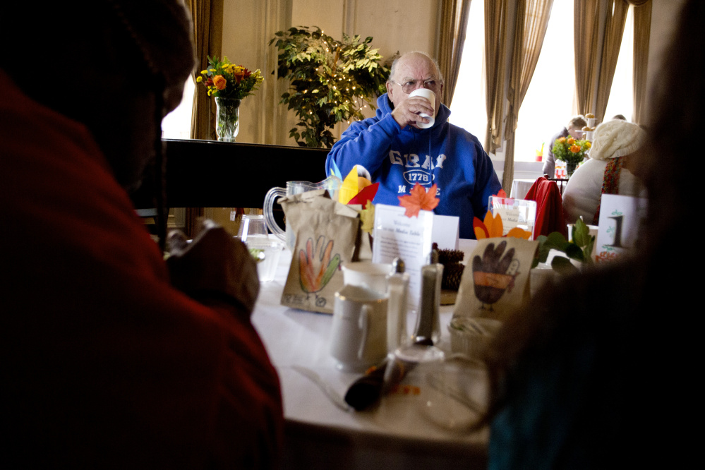 Bud Buzzell of Portland takes a sip of coffee after finishing his Thanksgiving meal at Wayside Food Programs’ community dinner at the Portland Club.