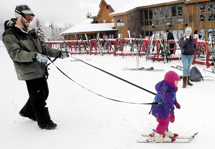 A father helps his daughter learn to ski at the Saddleback resort in Rangeley. The owners said in July that the resort would close if it couldn’t secure $3 million to replace an aging chairlift. This week they declined comment on Saddleback’s future.