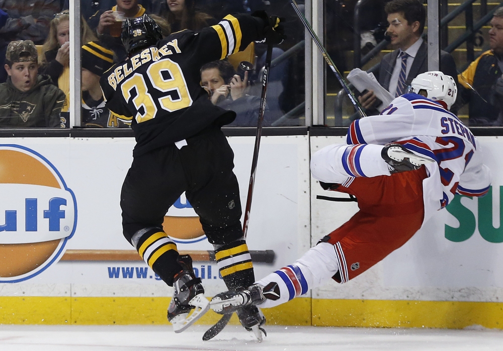Matt Beleskey sends the Rangers’ Derek Stepan into the boards in the second period of Friday’s game.