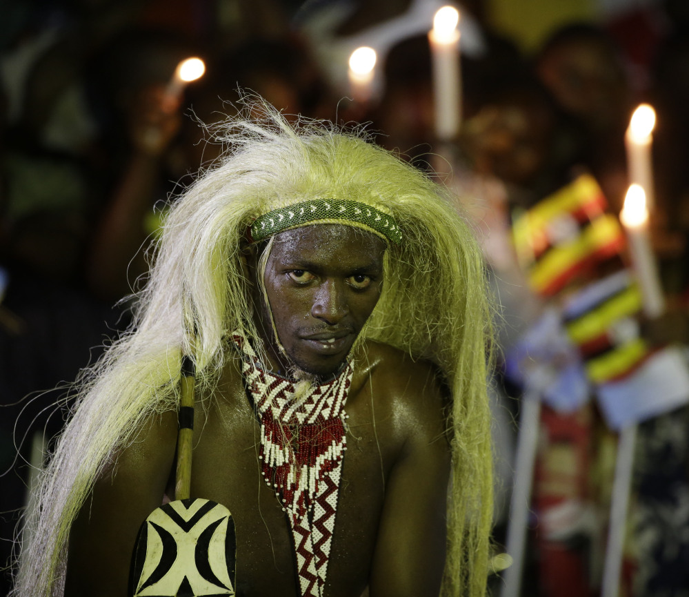 A man in traditional tribal clothing waits for the arrival of Pope Francis in Munyonyo, Uganda, on Friday. The Associated Press