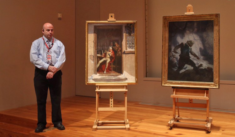 Portland Museum of Art security officer Shawn Higgins stands next to the two N.C. Wyeth paintings – ""Go Dutton, and that right speedily," left, and "The Encounter on Freshwater Cliff” – recovered in early October. They were among six stolen from Portland landlord Joseph Soley in 2013.. Whitney Hayward / Staff Photographer