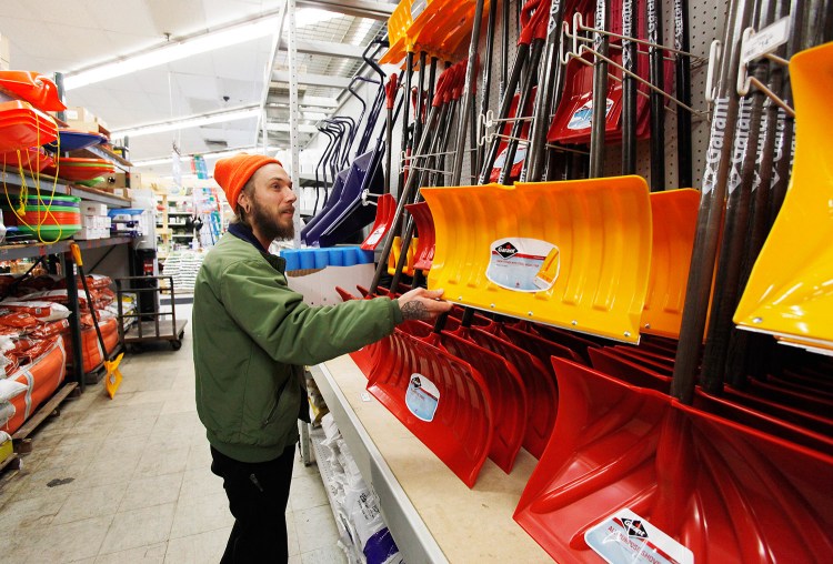 Patrick Libby selects a snow shovel to buy Monday at Maine Hardware in Portland, in preparation for Tuesday's storm. Libby moved to Portland from Florida in June.
Joel Page/Staff Photographer