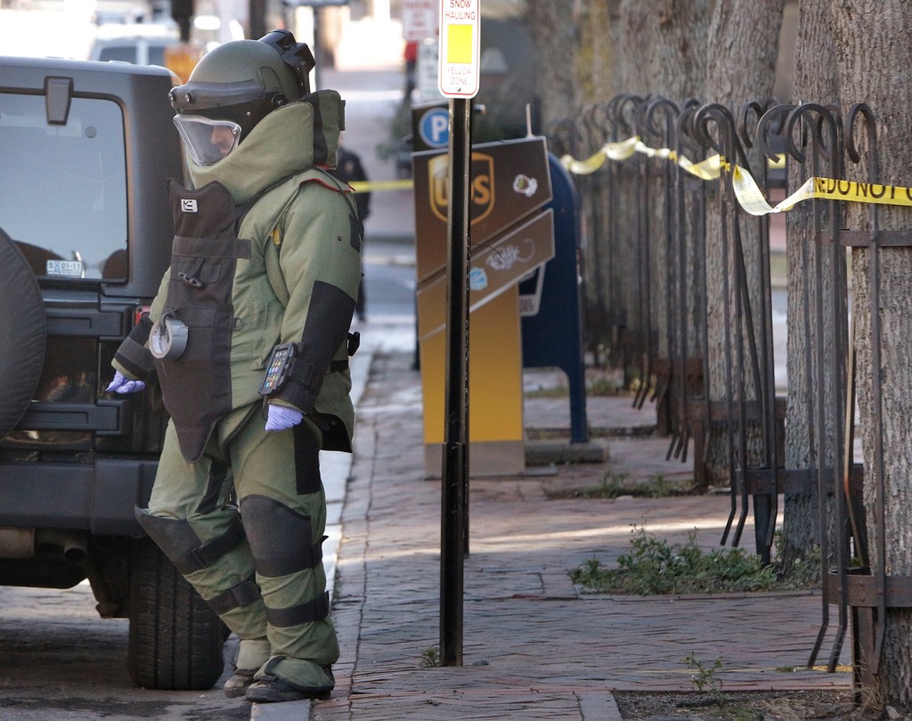A member of the Portland Police bomb squad returns to Middle Street while investigating a suspicious package that was found at 100 Middle Street in Portland on Monday. Gregory Rec/Staff Photographer