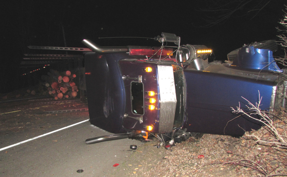 Maine State Police contributed photo
A pulp truck that overturned after it was hit by a car on U.S. Route 2 in Mexico Monday night. The driver of the car lost control after hitting a dead deer in the road and veering into the path of the truck.