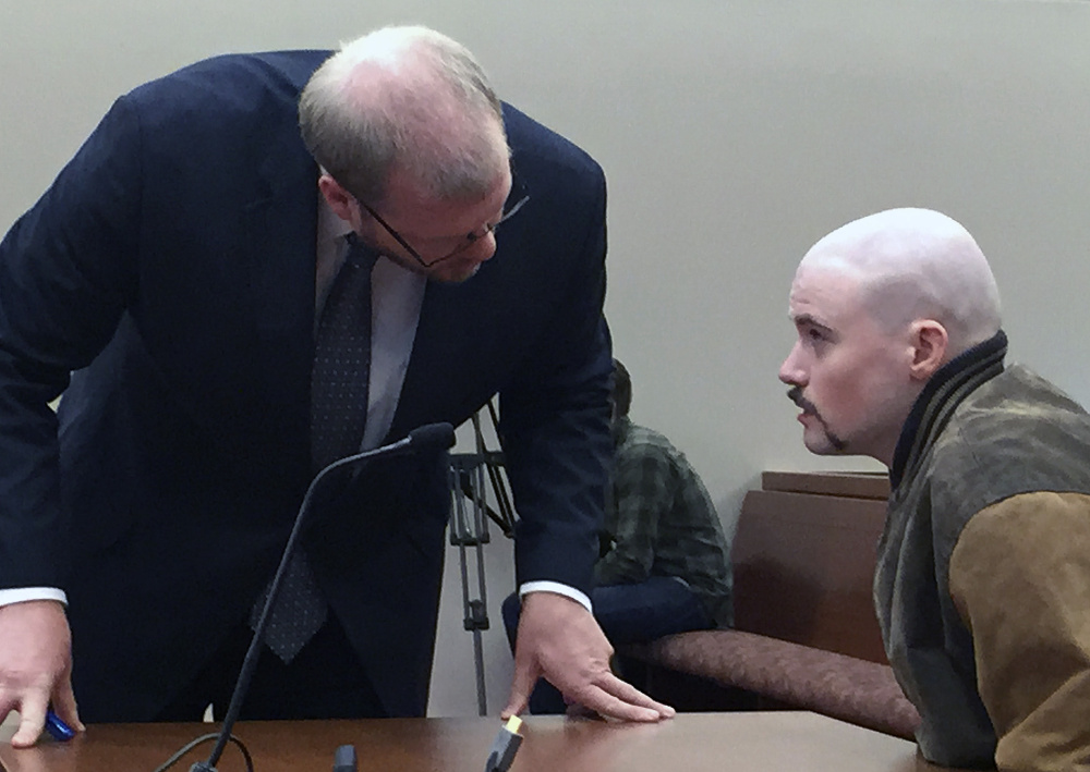 Attorney Scott Hess confers with his client, Leroy Smith III, during a hearing Wednesday in Augusta to determine whether the state can force Smith to take medication so he can stand trial.