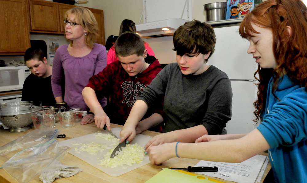 Skowhegan Area Middle School students make soup for their Empty Bowls project on Thursday. The money raised from sales of soup and hand-made bowls during the weekend Holiday Stroll benefits area soup kitchens and food pantries. From left are Jerrin Gold, teacher Jennifer Dorman, Philip Pickering, Tierra Evans and Kricket Magee.