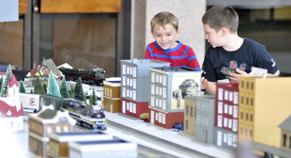 Gunnar Everett, 6, of Morrill, left, and Luke Camber, 7, of Union, watch the model trains running on Friday in the atrium outside the Maine State Museum in Augusta.
