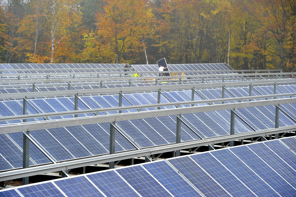 Workers and master electricians install solar electric panels as owners of Mt. Abram Ski Area installing more than 800 solar electric panels in October.