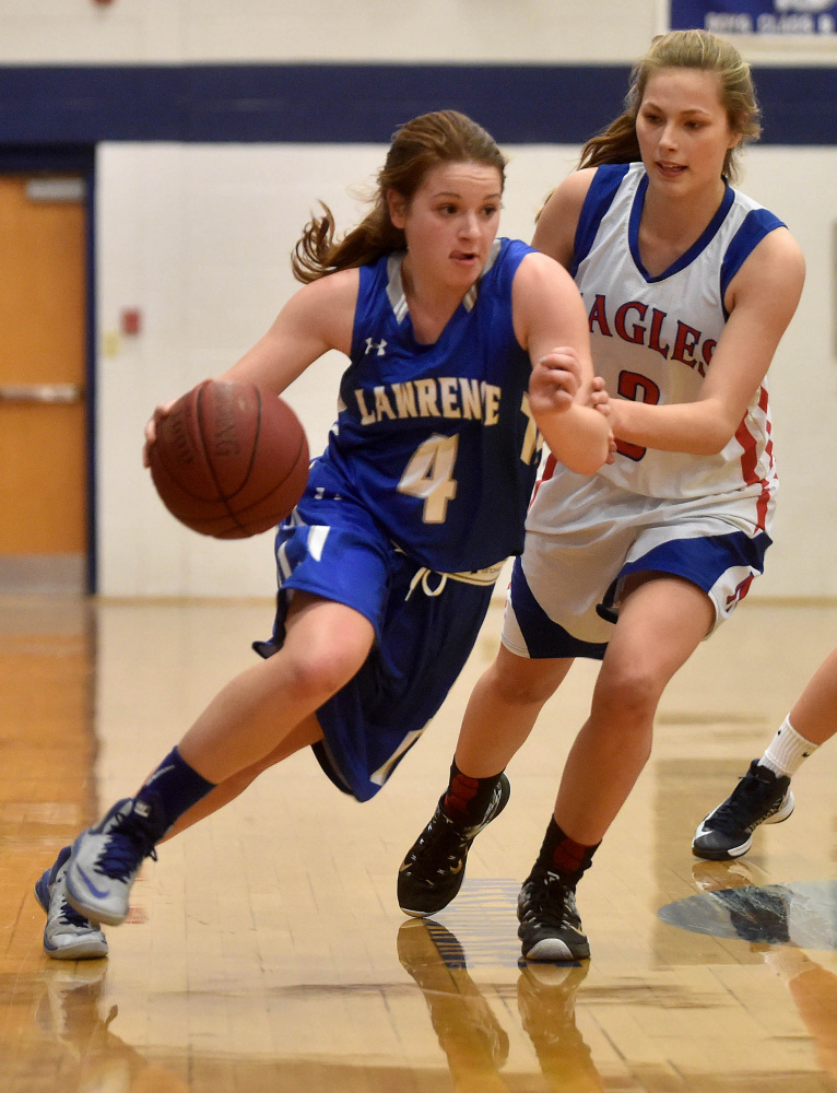 Lawrence’s Morgan Boudreau, left, drives past Messalonskee guard Sophie Holmes during a Class A North season-opening game Friday night in Oakland.