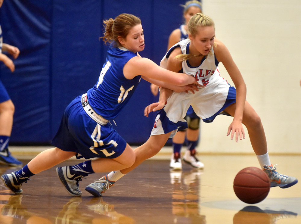 Lawrence’s Morgan Boudreau, left, battles for a loose ball with Messalonskee’s Ally Turner during a Class A North season-opening game Friday night in Oakland.