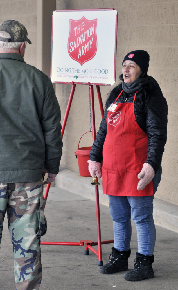 Tammy Sumabat, right, chats with a customer last week while collecting donations for the Salvation Army outside Sam’s Club in Augusta.