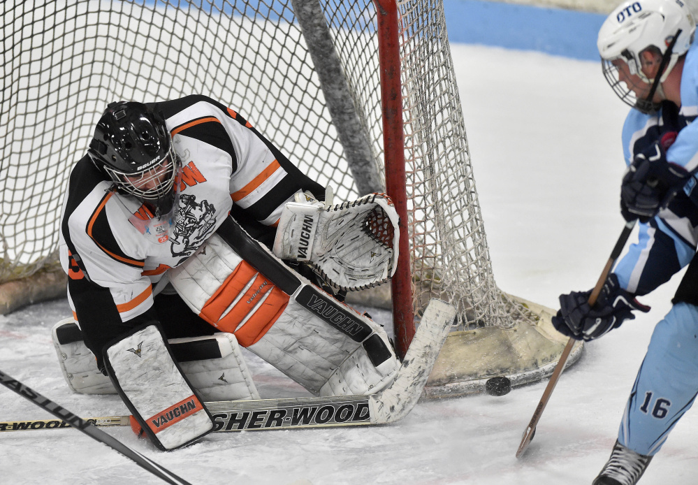 Winslow goalie Andrew Beals makes a save during a Class B North game against Old Town/Orono on Saturday night at Sukee Arena. Beals finished with 17 saves in a 3-1 victory.