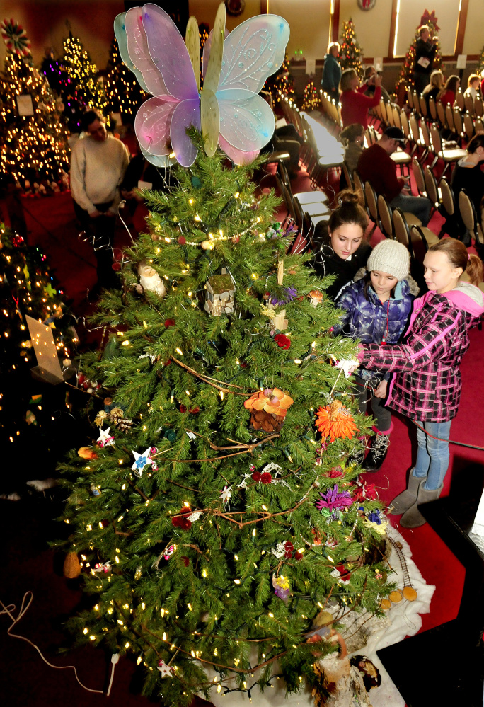 Bree Labbe, from left, Shelbie Poulin and Calia Williams said the Fairyland tree was their favorite during the Festival of Trees at Good-Will Hinckley on Sunday.