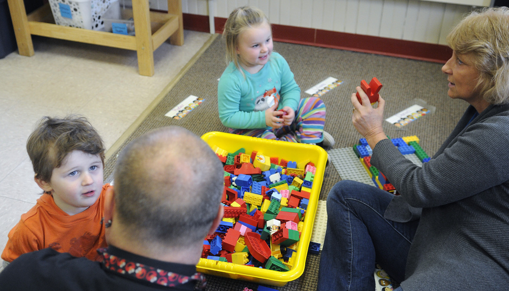 Head Start students Emberlynn Beaulieu and Ryder Chase play Tuesday with Webster Head Start assistant teacher Sharon Bissonnette and education technician Ervin Fyle at the Augusta school.
