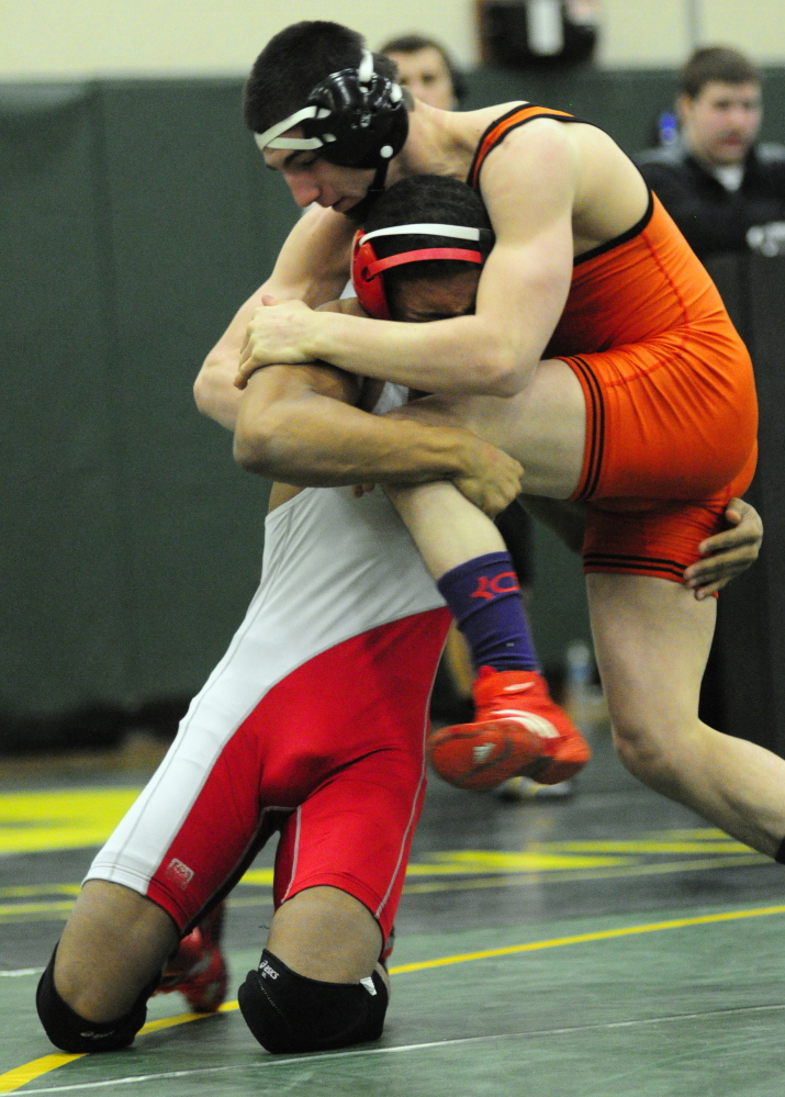 Cony’s Zeko Caudill, left, and Skowhegan’s Julian Sirois compete in the 138-pound finals at the Eastern A championships last season. Sirois won his 150th career match at the Westbrook Invitational. He is wrestling at 160 pounds this season.