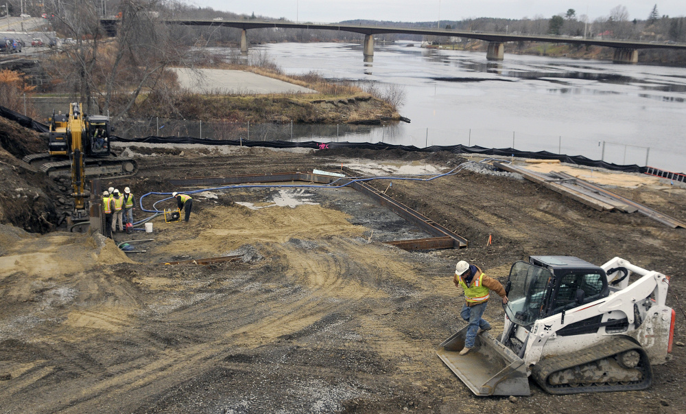 Workers with Sargent Corporation excavate a hole Tuesday for a 400,000 gallon sewer storage tank at the confluence of Cobbossee Stream and the Kennebec River in Gardiner, part of the city’s upgrade to the sewer infrastructure in the community.