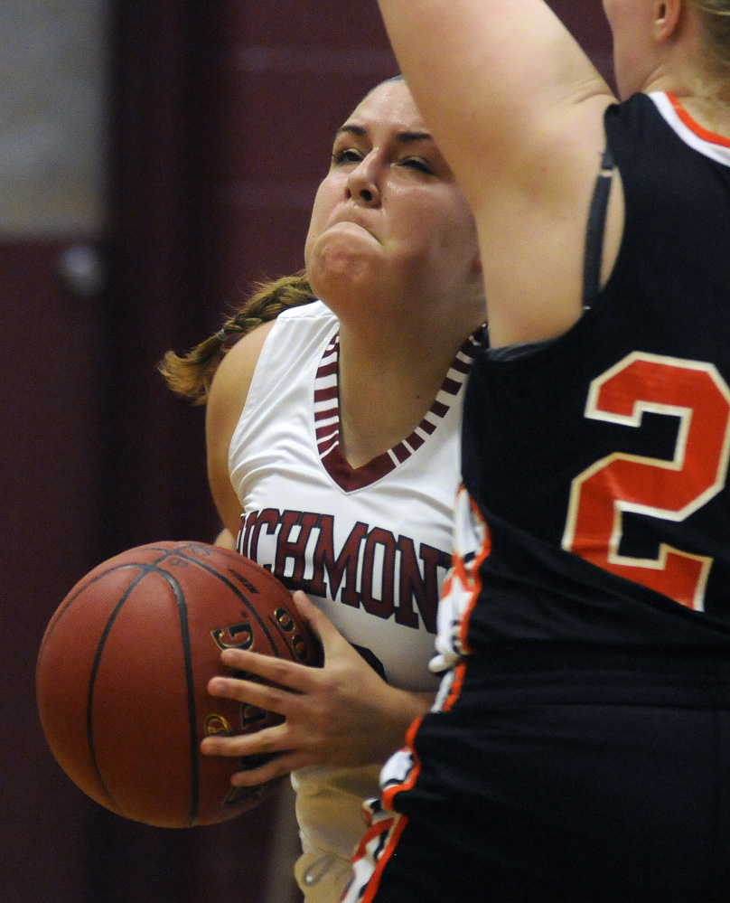 Richmond High School’s Emily Douin tries to get around North Yarmouth Academy’s Sydney Plummer  on Wednesday in Richmond.
