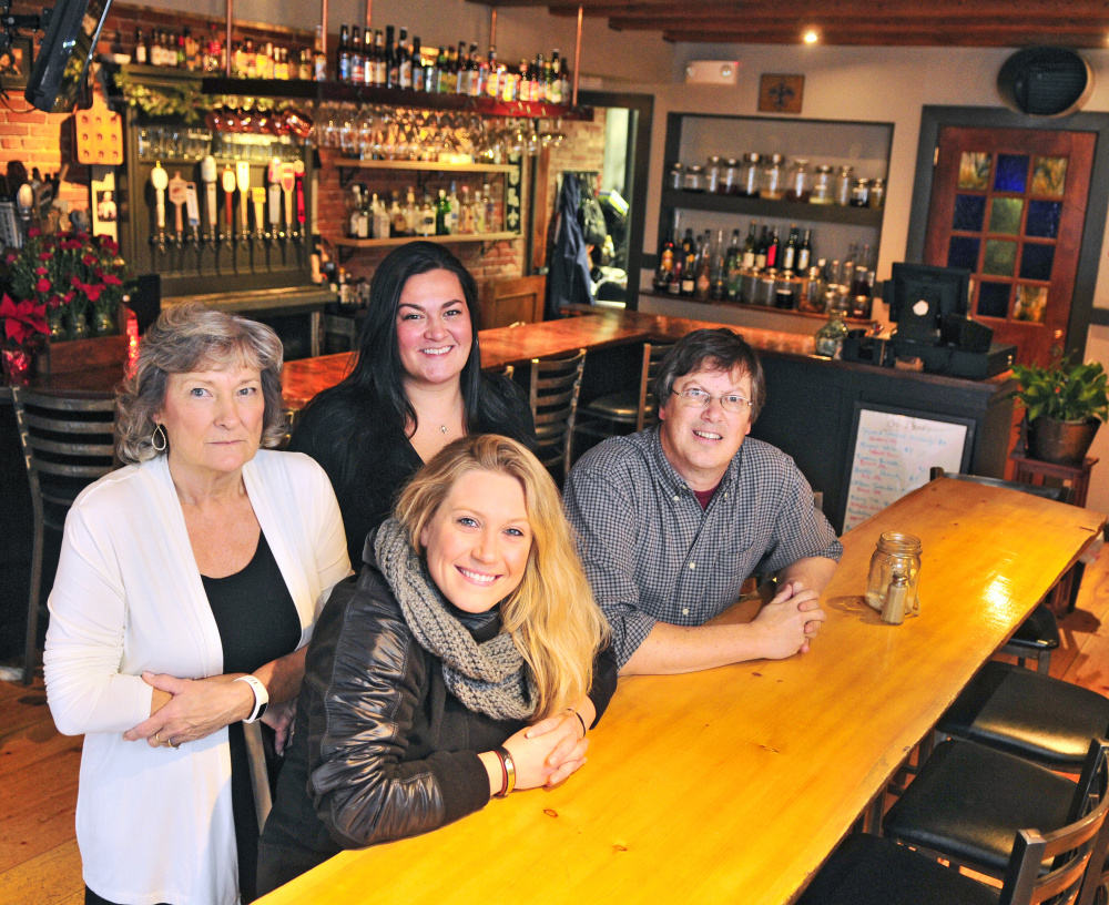 Coby Thibeau, back row left, and daughter Deanna Thibeau along with Leah Sampson and Geoff Houghton pose for a photo on Thursday at the Maine House in Hallowell, where the Thibeau family is working to sell the business to Sampson and Houghton.