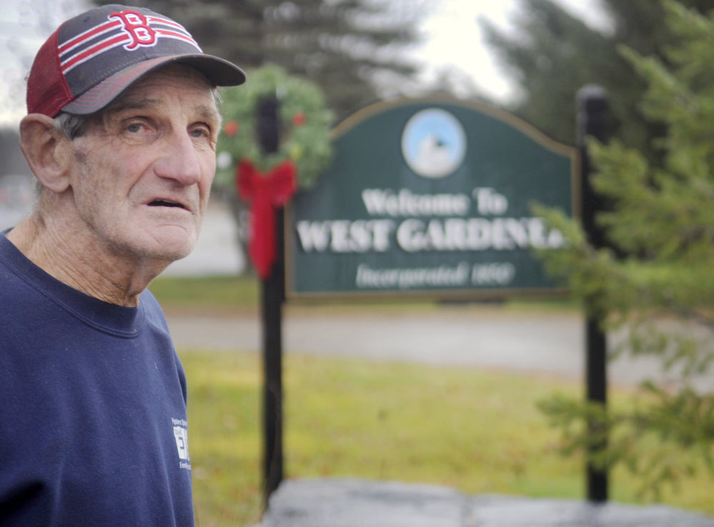 West Gardiner Selectman Mert Hickey stands at the town’s welcome sign on Thursday at the border with Gardiner. Three of the town’s welcome signs have been stolen.