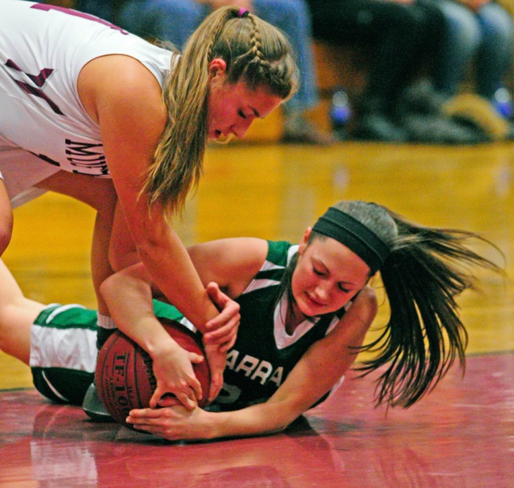 Monmouth’s Hannah Anderson, top, battles for a loose ball with Carrabec’s Liberty Chestnut on Thursday  in Foster Gym at Monmouth Academy.