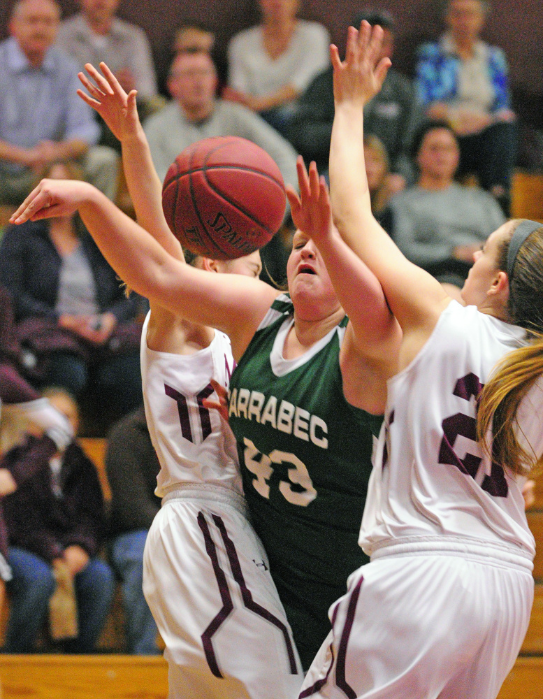 Monmouth Academy’s Emily Grandahl, left, and Haley West double team Carrabe’s Kate Stevens on Thursday in Foster Gym at Monmouth Academy.