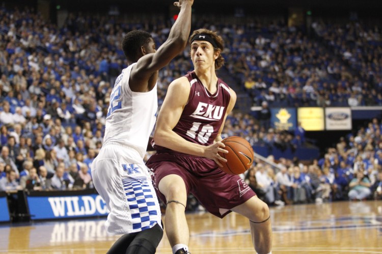 Eastern Kentucky forward Nick Mayo, left, drives to the basket during a game against No. 5 Kentucky on Wednesday night. Mayo scored nine points and is averaging 11.9 per game this season.