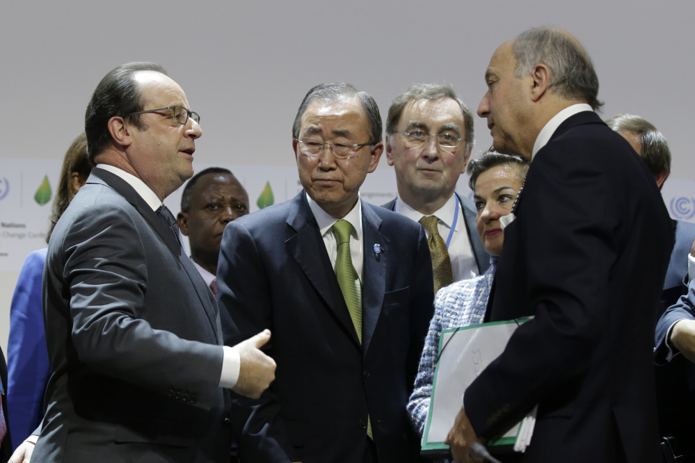 French President Francois Hollande, left, United Nations Secretary-General Ban Ki-moon, center left, Christiana Figueres, 2nd right, Executive Secretary of the UN Framework Convention on Climate Change and Foreign Affairs Minister and President-designate of COP21 Laurent Fabius, right, speak together at the end of a plenary session at Le Bourget, near Paris, France, Saturday.