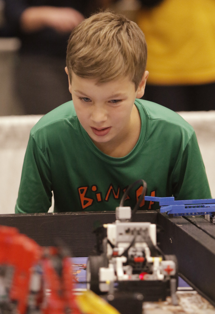 Jacob Gross, a fifth-grader at Dora L. Small Elementary School in South Portland, watches as his team’s robot makes its way across a table Saturday on its way to competing a mission during the Maine FIRST LEGO League State Championship at the Augusta Civic Center. Sixty teams from around the state competed in the championship.