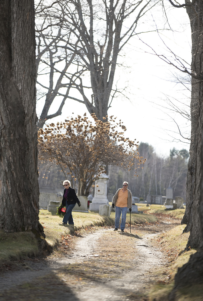 Rod and Lydia Tenney, of Gardiner, lay wreaths Saturday on veterans’ graves in Oak Grove Cemetery in Gardiner. Organizer Steve Hanley of American Legion Post 4 in Gardiner said 525 veterans are buried in area cemeteries, but his group could raise only enough money to buy 230 wreaths for the graves.