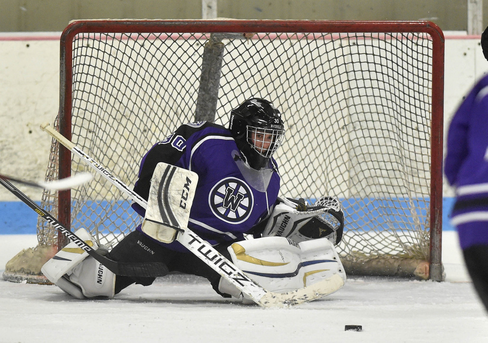 Waterville Senior High School goalie Nathan Pinette (30) makes a save against Winslow High School on Saturday at Sukee Arena in Winslow.
