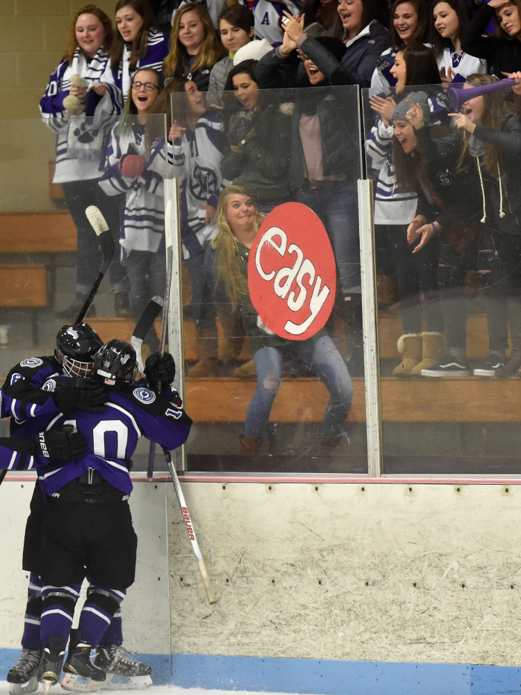 Waterville Senior High School celebrate Justin Wentworth’s first period goal against Winslow High School on Saturday at Sukee Arena in Winslow.