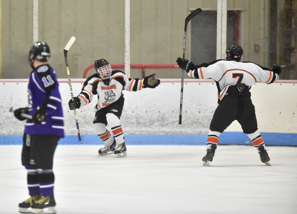 Winslow High School’s Tommy Tibet’s (8) celebrates his first period goal against Waterville Senior High School with teammate Jimmy Fowler, right, Saturday at Sukee Arena in Winslow.