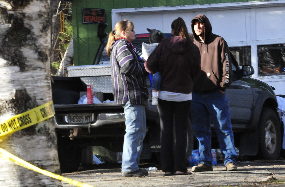 Friends and family members of Jon and Betty Belanger Sunday arrive at the scene of the Saturday night fire that did serious damage to the Belanger home in Oakland.  At left is family friend Kathy Gray and the homeowner’s brother, Ben Belanger is at right.