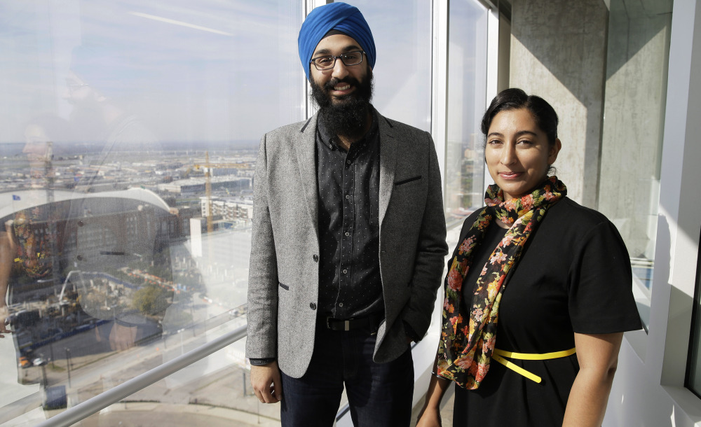 In this Dec. 11, 2015, photo, Darsh Singh, left, poses for a photo with his wife, Lakhpreet Kaur, in Dallas.
