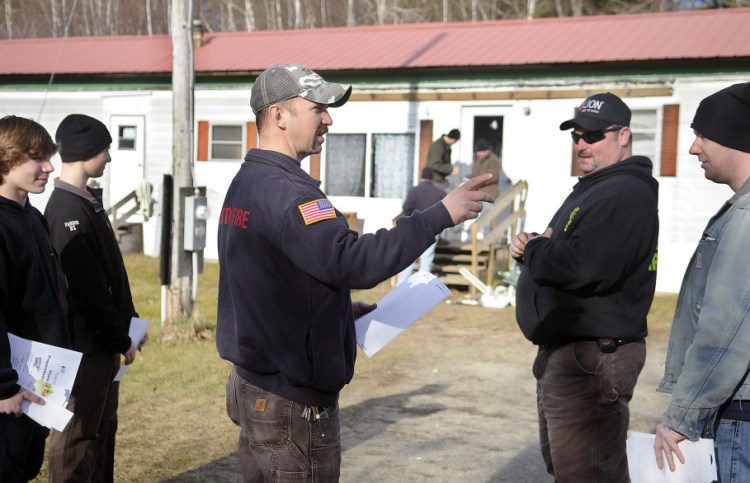 Pittston Fire Chief Jason Farris, center, directs fellow volunteers on Sunday to hand out fliers to residents that offer free fire detectors. Anyone who contacts the town office at 582-4438 before Dec. 18 will receive a detector along with free installation by the Fire Department. The installations will take place between 9 a.m. and 3 p.m. on Jan. 2, Farris said. He said there is no limit on the number of detectors firefighters can give out during the Home Fire Preparedness Campaign. Residents can have just two minutes to get out of a house once a fire breaks out, according to the American Red Cross. People die in a fire an average of seven times every day in the U.S., and someone is hurt every 40 minutes.